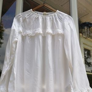 Sold.   White, soft top with scallop trim and details